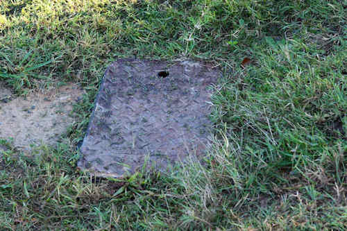 Water meter box with lid removed showing meter inside
